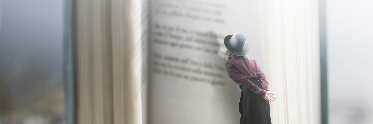 Curious woman reads a giant book.