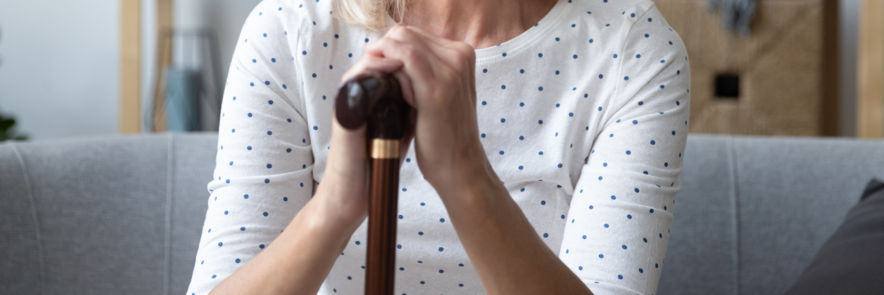 Deciding to Use a Mobility Aid for Walking With Cerebral Palsy Woman using a cane.
