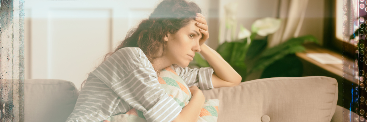 What My 'Quiet Meltdowns' Look Like as a Neurodivergent Adult Stressed woman sitting on sofa.