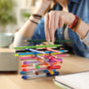 Woman with ADHD fidgeting by stacking pens.