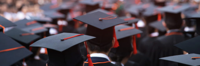 close up of graduation caps at commencement