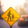 school zone warning signing on blurred traffic street