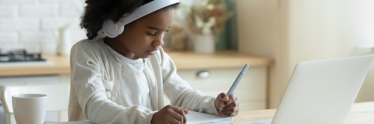 U.S. Government to Give $3 Billion to Support Disability Services A young Black girl writing something done while participating in a virtual class