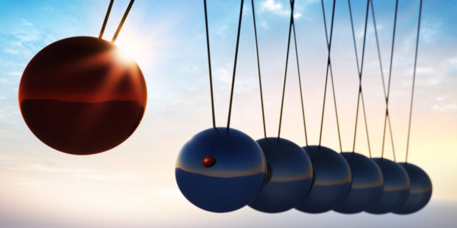 silver and one red metal balls on a white background