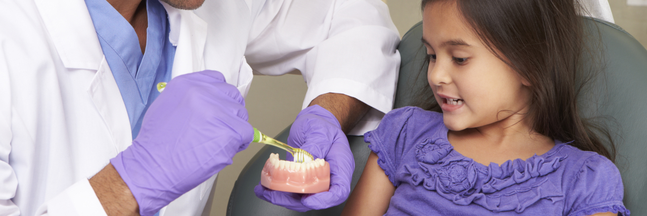 Dentist with child patient.