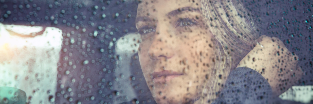 When the Doctor Treating My Chronic Pain Said I'll Never Be Pain-Free Sad woman sitting in the car in rain.