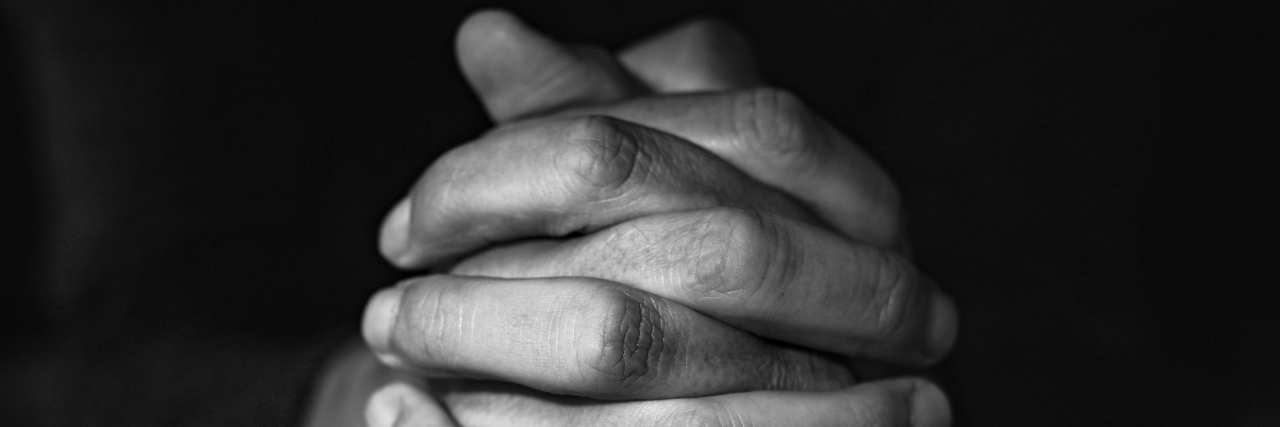 man's hands clasped
