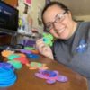 Photo of contributor holding craft projects of foam pieces that made little turtles