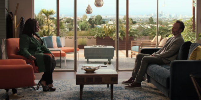 screenshot of HBO's "In Treatment" showing therapist and patient facing each other on chairs with huge windows behind them