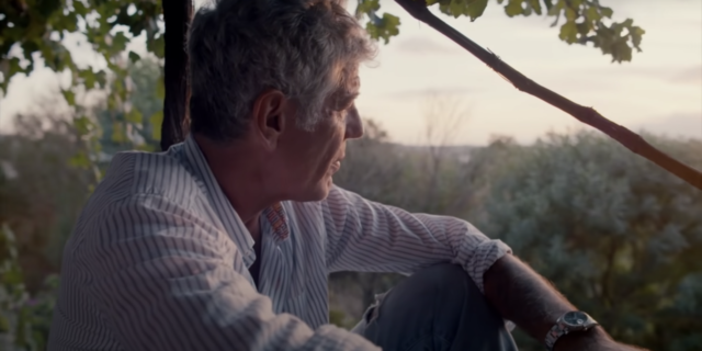 How ‘Roadrunner’ Gives a Glimpse into Anthony Bourdain’s Mental Health Challenges screenshot of Anthony Bourdain watching the sunset
