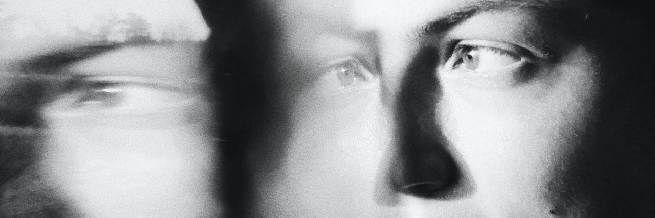 blurred black and white photo of a woman looking sad, double exposed