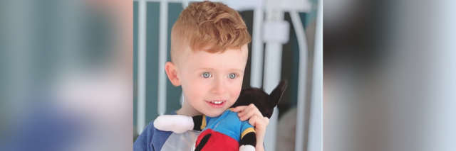 Jacquelyn's son holding a plush toy.