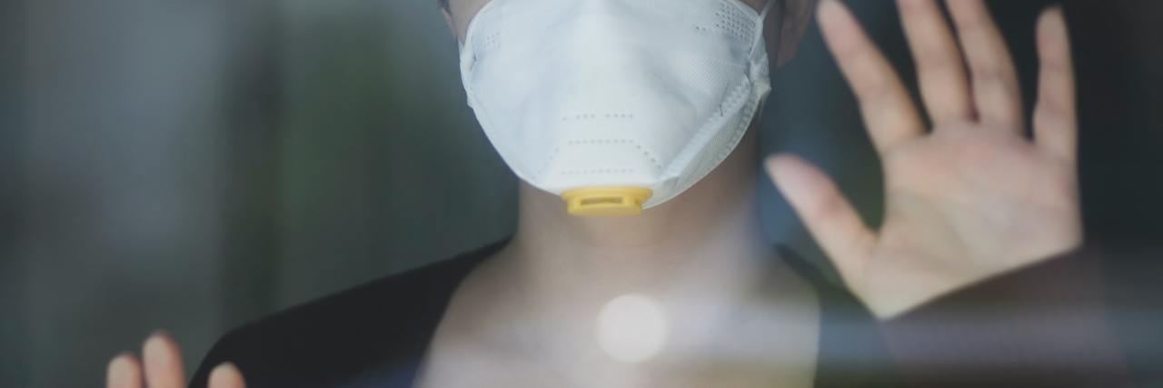 Newly Developed Social Anxiety Due to Living Post COVID-19 person looking out a glass window during covid-19