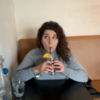 Photo of contributor taking a sip from a drink with a straw and little umbrella