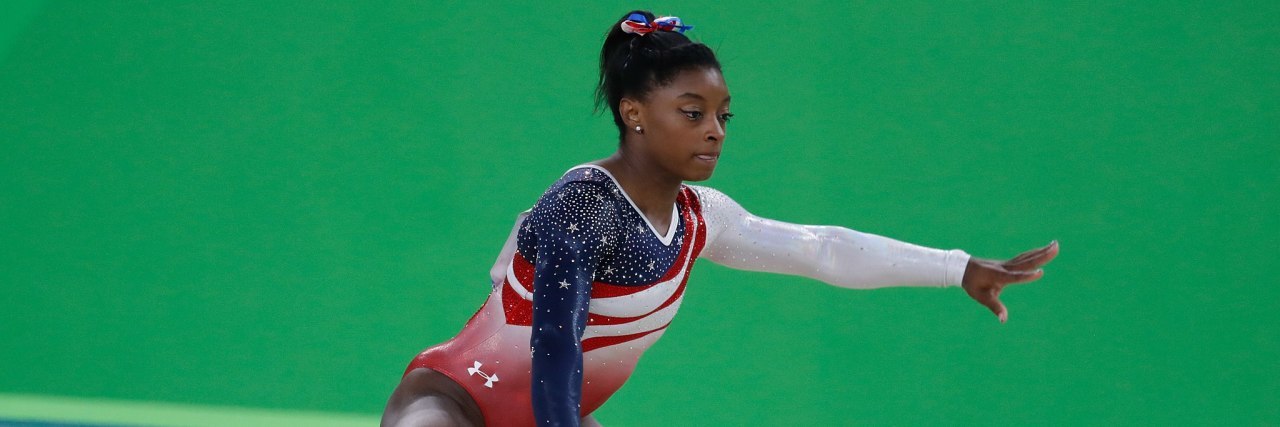 Why I Admire Simone Biles as Someone With Mental Health Challenges Simone Biles competing in floor exercise.