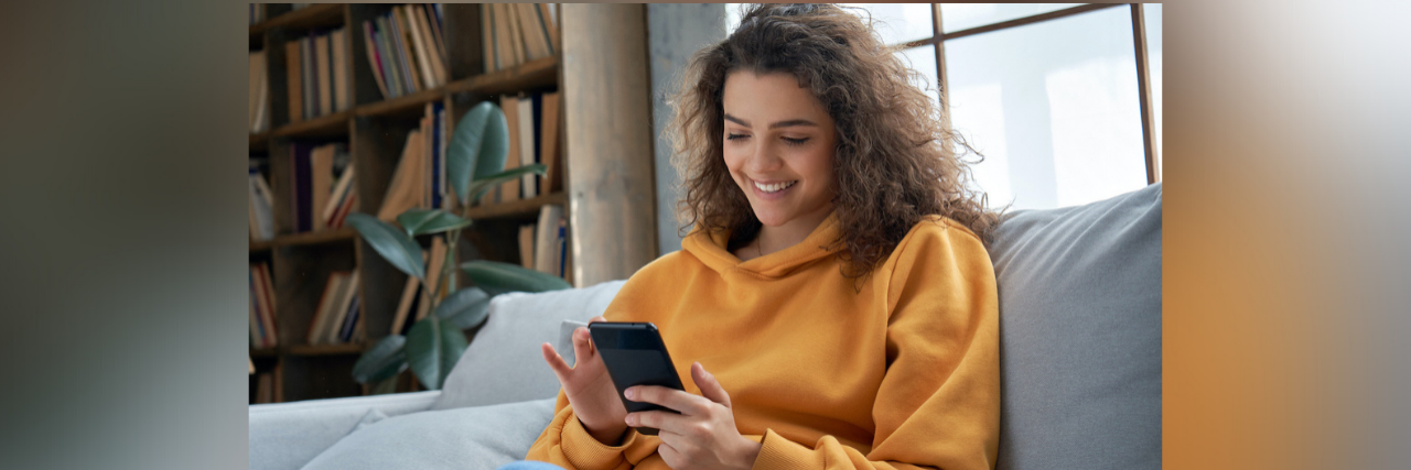 How Teens Handled Loneliness, Fear and Isolation During the Pandemic Hispanic teen smiling and texting at home