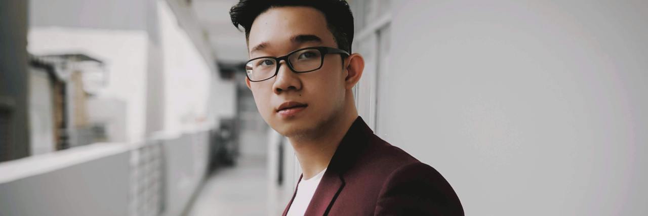 I’m Not Scared to Admit My Suicide Attempt Anymore photo of man in blazer dinner jacket and white t-shirt, smiling for camera