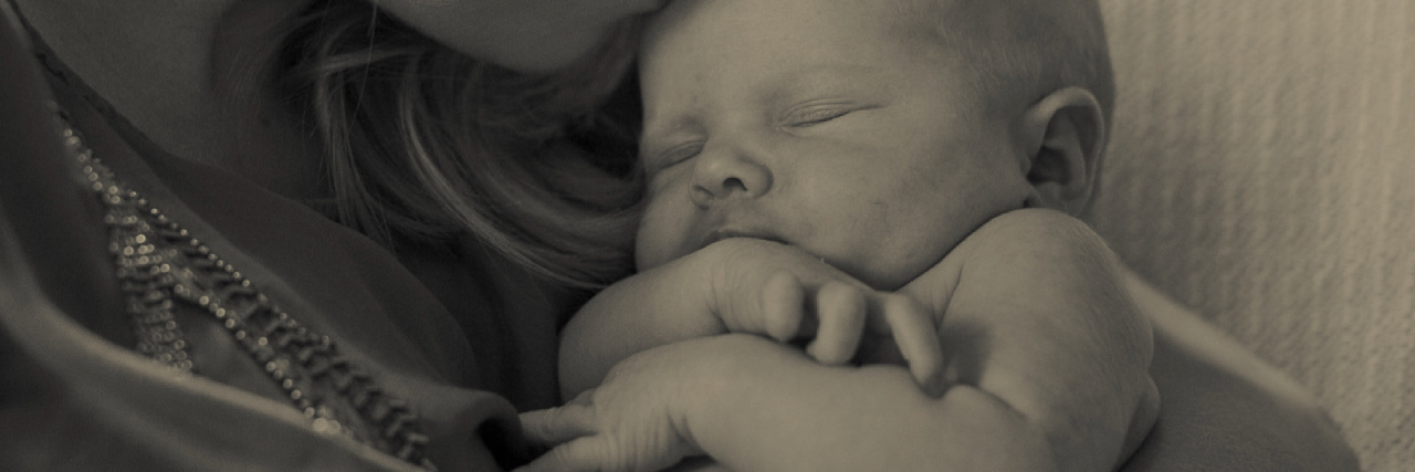 Why I Think Therapy Could Help You Too a mother kissing her baby on the forehead