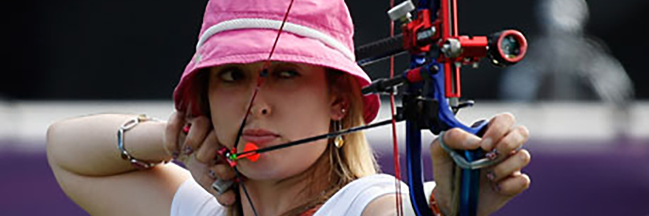 Danielle is competing in London 2012 in archery. She is aiming her bow at the target.