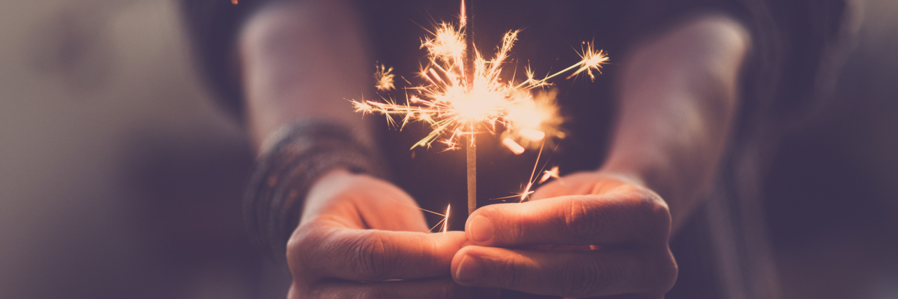 How Dialectical Behavior Therapy Skills Are Changing My Life close up of people hands with red fire sparklers