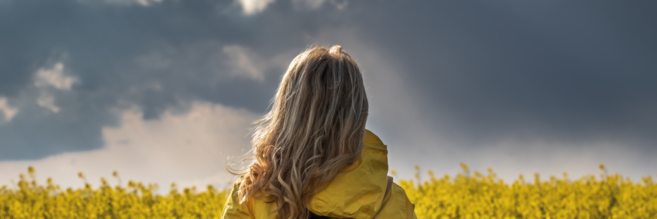 Why Saying 'You Can Do Anything If You Try Hard Enough' Is Harmful Woman looking at storm.