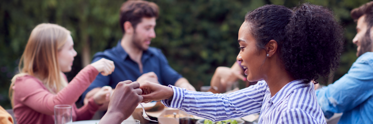 Stop Changing Your Food Plans for Me Friends enjoying picnic together outdoors.