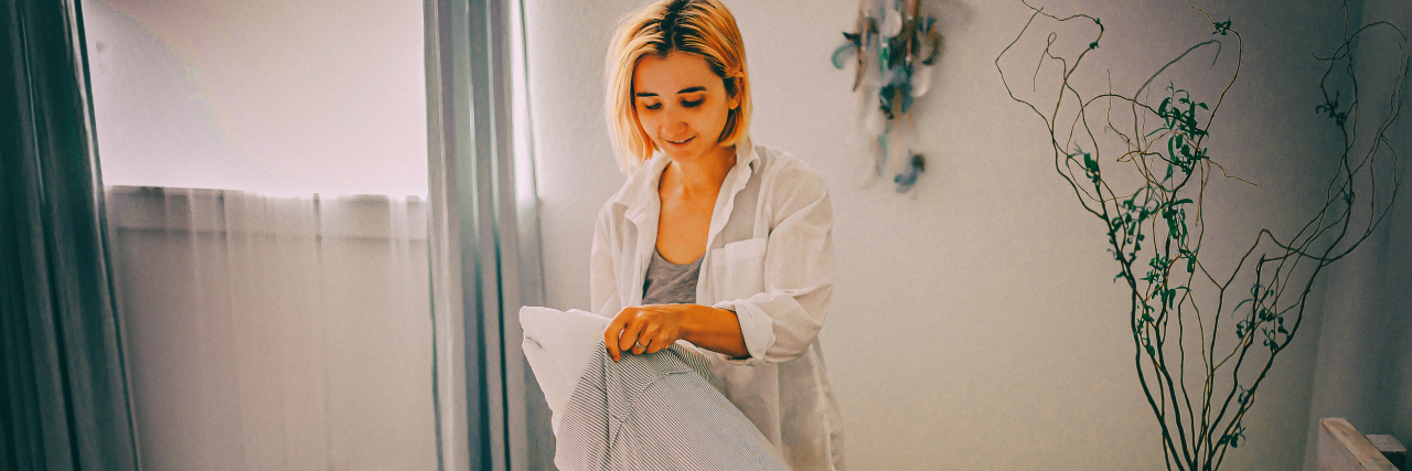 4 Little Wins Against Fibromyalgia Today Woman making bed.