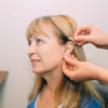 A woman getting her hearing aids adjusted