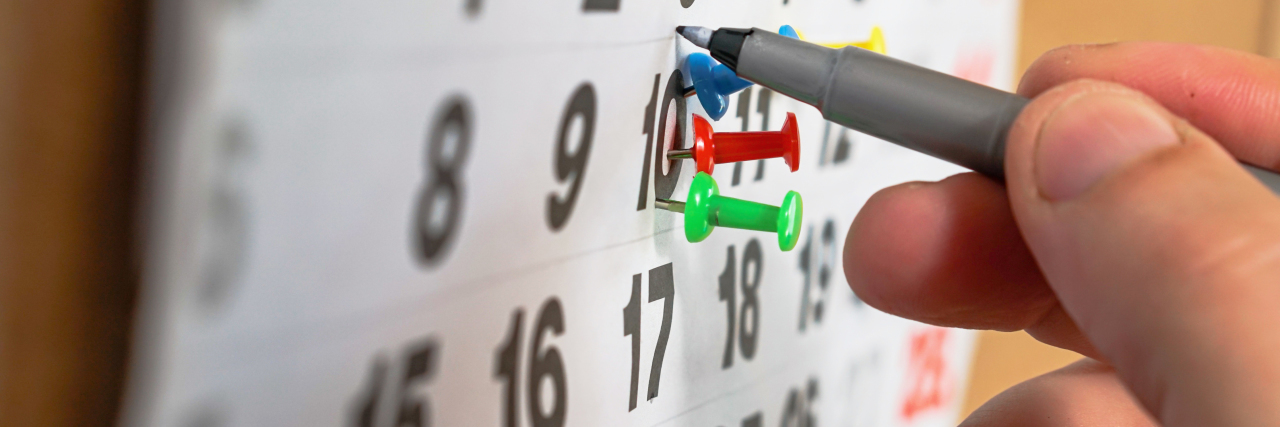 How Trauma Presents Physically When an Anniversary Approaches a person circling a date on a calendar