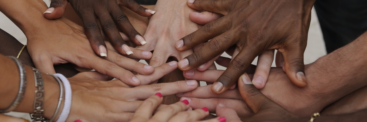 Diverse human hands showing unity.