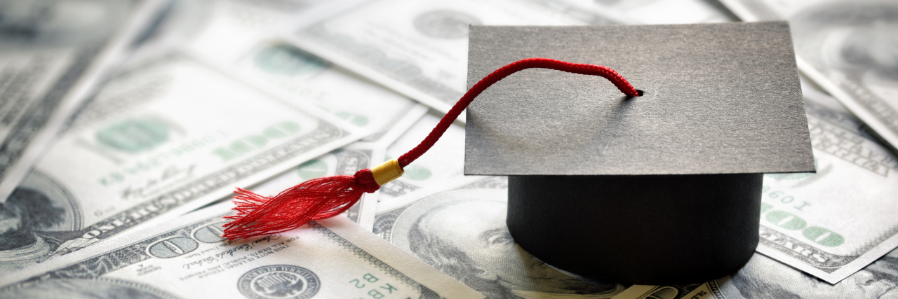 Biden to Cancel Student Debt for over 300,000 Disabled People Graduation cap on united states dollar money