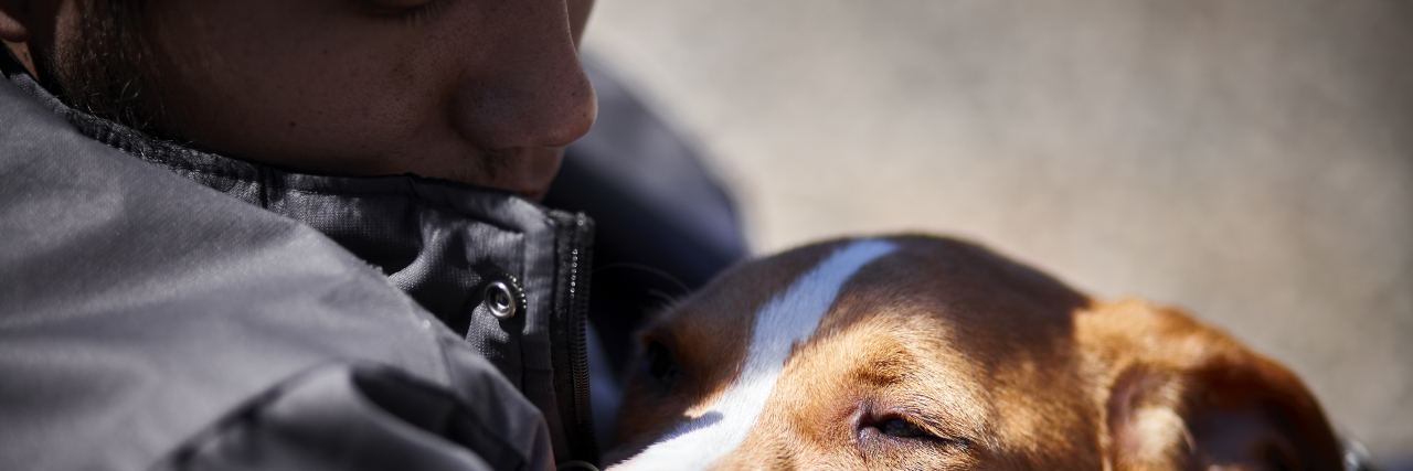 The VA Will Finally Fund Service Dog Training for Veterans man holding sleepy puppy dog closeup selective focus daylight