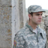 Man in Army uniform looking away thoughtfully