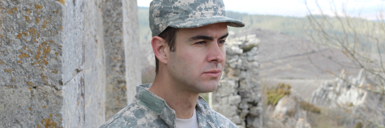 Why I Choose Not to Have Children as Someone With Schizophrenia Man in Army uniform looking away thoughtfully