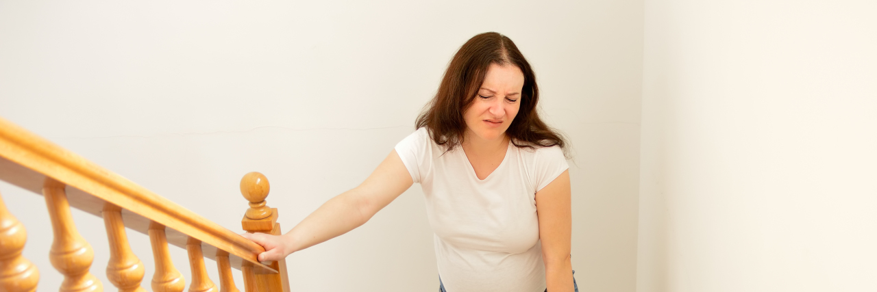 Someone With Fibromyalgia Can Look 'Able-Bodied' but Be in Pain Tired woman walking up stairs.