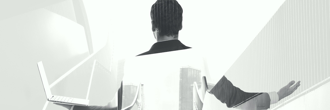 When Should You Disclose a Bipolar Disorder Diagnosis? a man holding a computer with his hands out