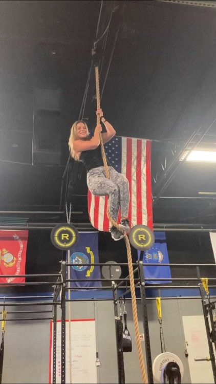Allison climbing a rope in CrossFit.