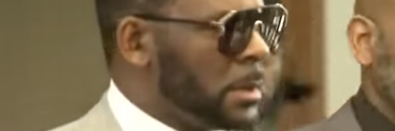 screenshot of R. Kelly wearing sunglasses during period of trial for sexual abuse allegations