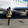 photo of Travis Barker from Blink-182 and Kourtney Kardashian in front of a private jet after his first flight since his 2008 plane crash
