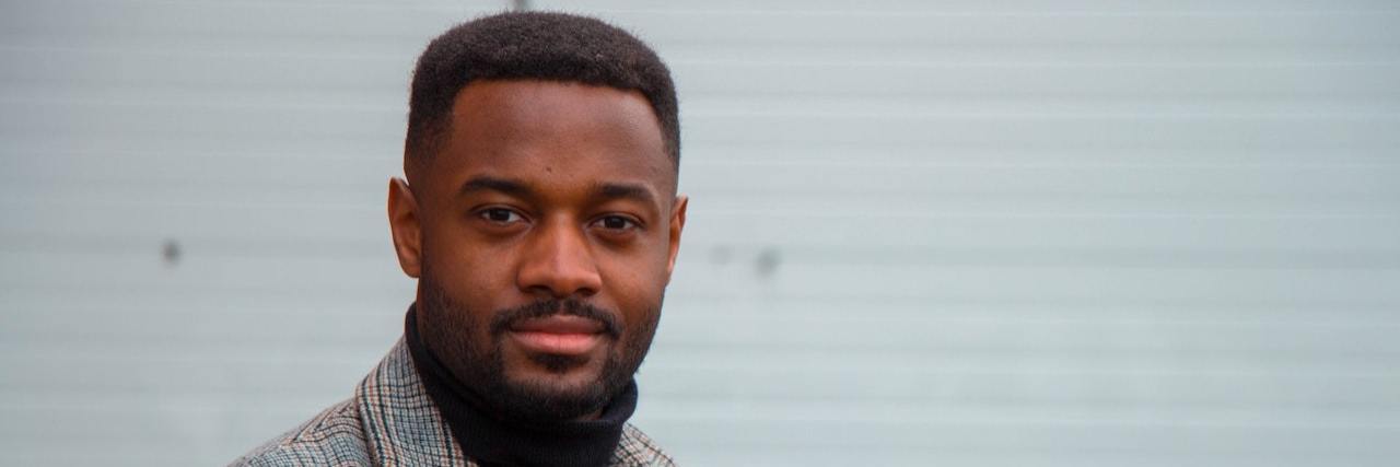 Reflecting on Life After My First Major Manic Episode Photo of Black man wearing blazer and confidently looking at camera