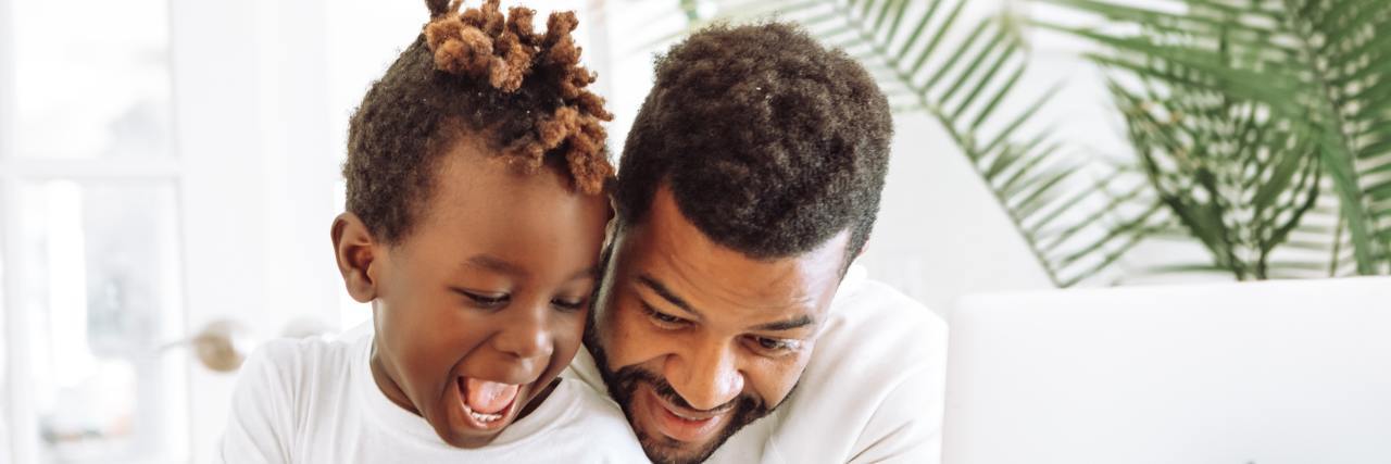 Parenting My Toddler: Time Out vs. Time In Black father and child smiling in front of a plate of food