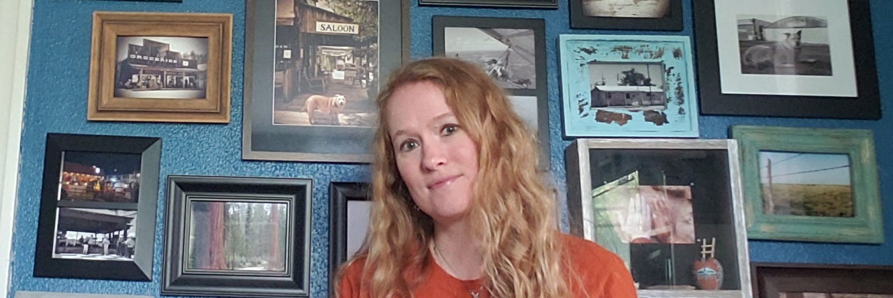 10 Unconventional Tips for Managing Fibromyalgia Christina at home with many pictures on the wall.