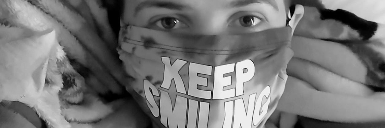 Person wearing a mask that says "Keep Smiling."