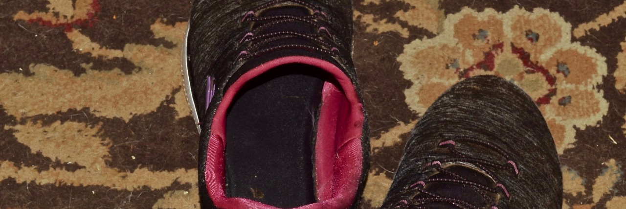 Developing Resilience as a Stroke Survivor A pair of black and pink tennis shoes on a rug.