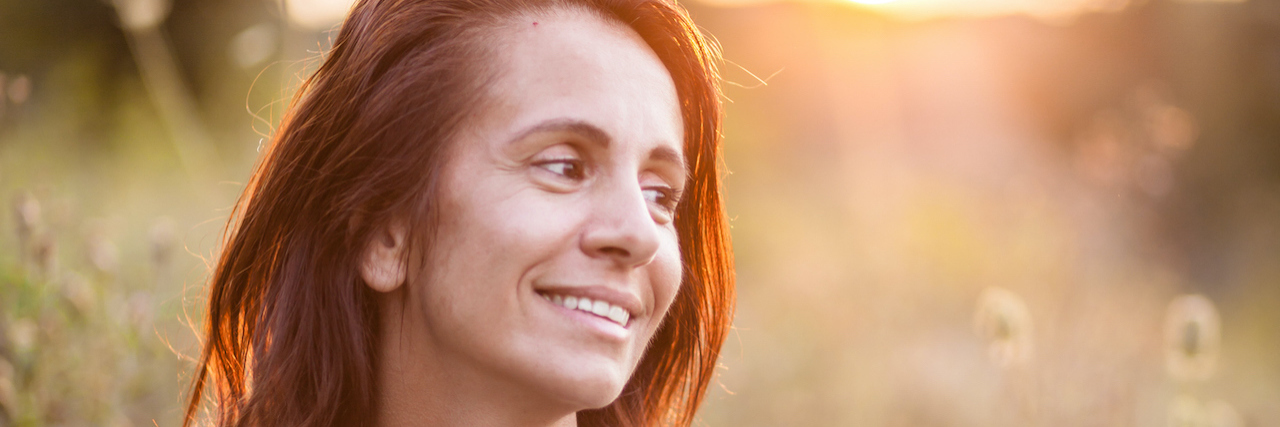 The Importance of Researching Symptoms and Diagnoses Woman sitting in a field at sunset