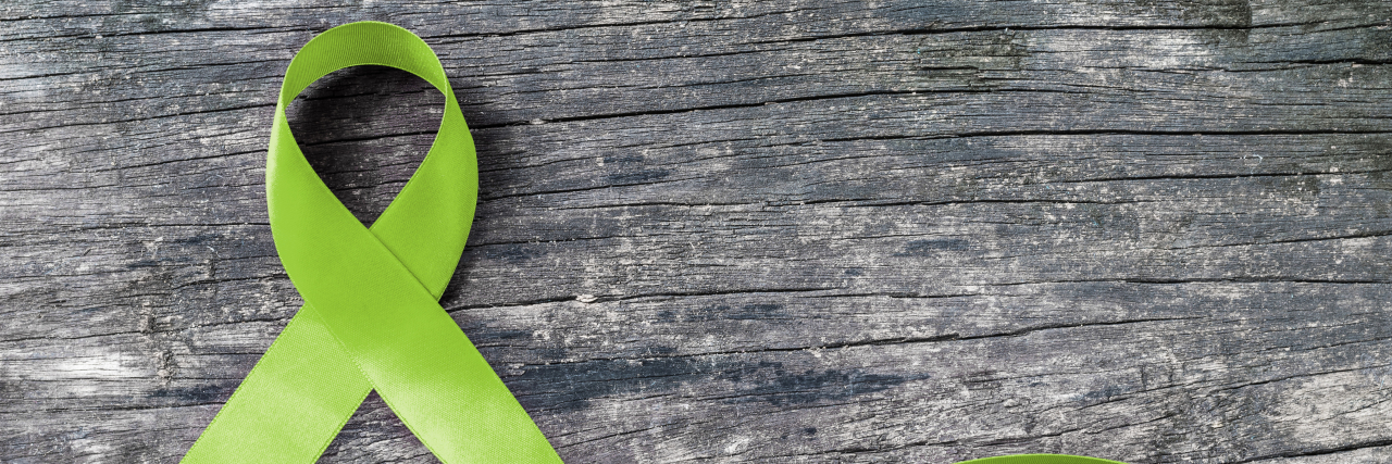5 Ways to Celebrate Mitochondrial Disease Awareness Month Green ribbon for mitochondrial disease awareness.