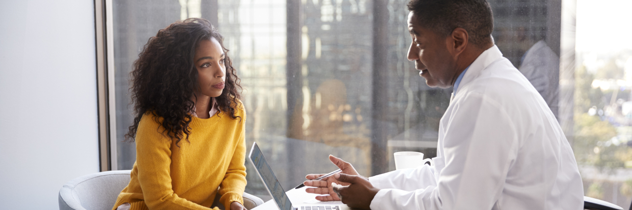 What to Do If You Got Bad News About Your Health Woman receiving bad health news from doctor.