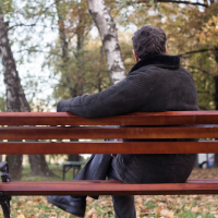 Man sitting on a park bench.