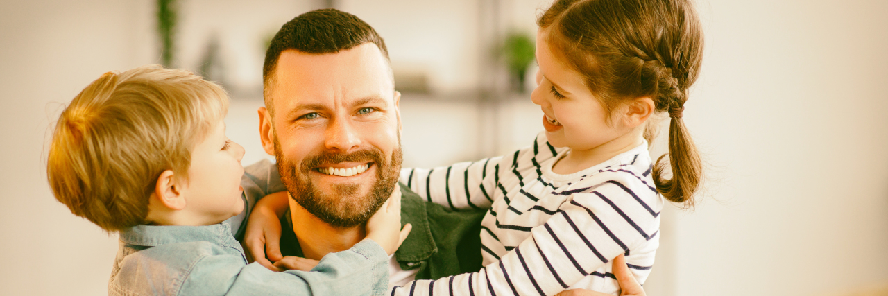 What I Wish I Could Tell My Younger Self About Parenting Kids hugging father.