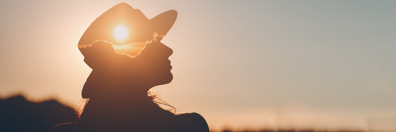 How It Feels Being on a Monitoring System for Heart Disease silhouette of a woman staring at the sunset